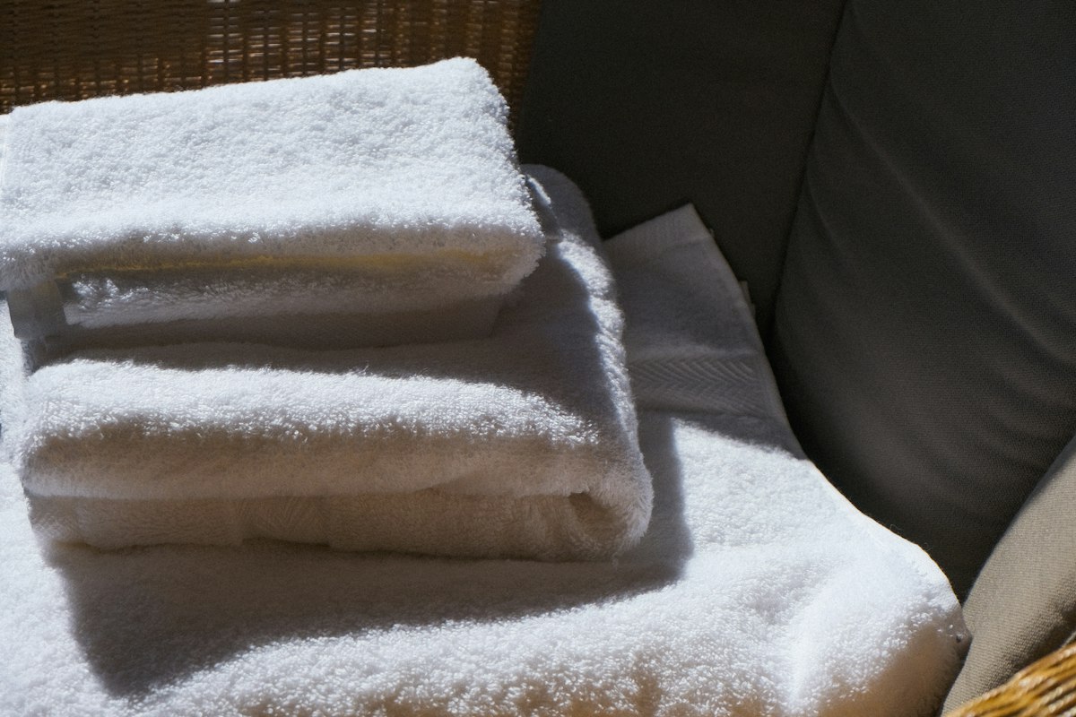 Fresh, neatly folded white towels after a house cleaning